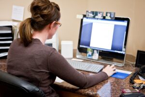 person works on a desktop computer