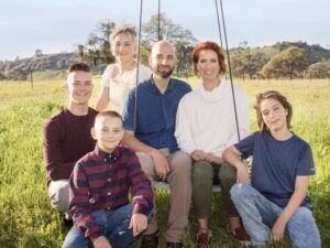 family photo with a mother, father and four children