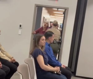a person being removed from a meeting