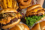 Three Hammy’s smash burgers with cheese, bacon and lettuce, served with fries.