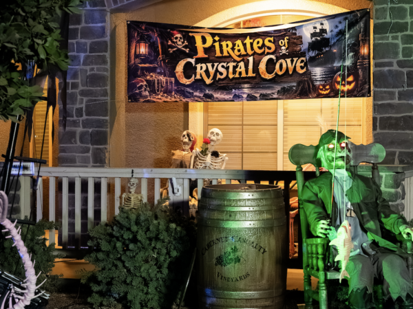 A Visalia home's front yard decorated with a pirate ship, skeletons and Halloween props.