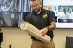 man holding a roll of paper