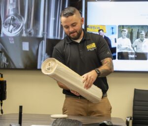 man holding a roll of paper