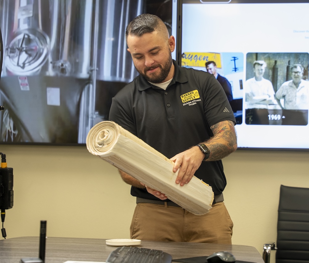 man holding a roll of paper