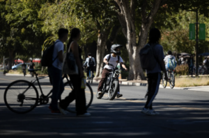 people riding bikes on a college campus