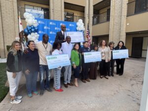 Assemblywoman Esmeralda Soria and community leaders pose with ceremonial checks announcing state funding for food assistance and senior meal programs in Fresno County.