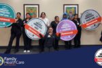 medical personnel holding posters of awards