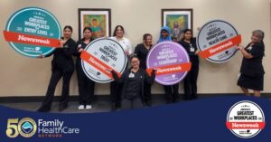 medical personnel holding posters of awards