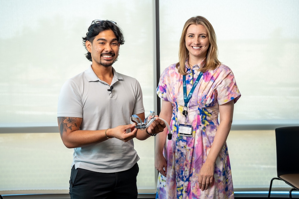 two people posing with a medical device